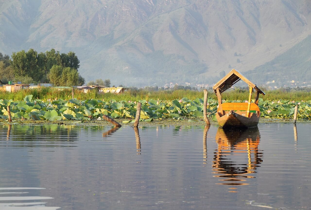An empty wooden shikara on Dal Lake in Srinagar