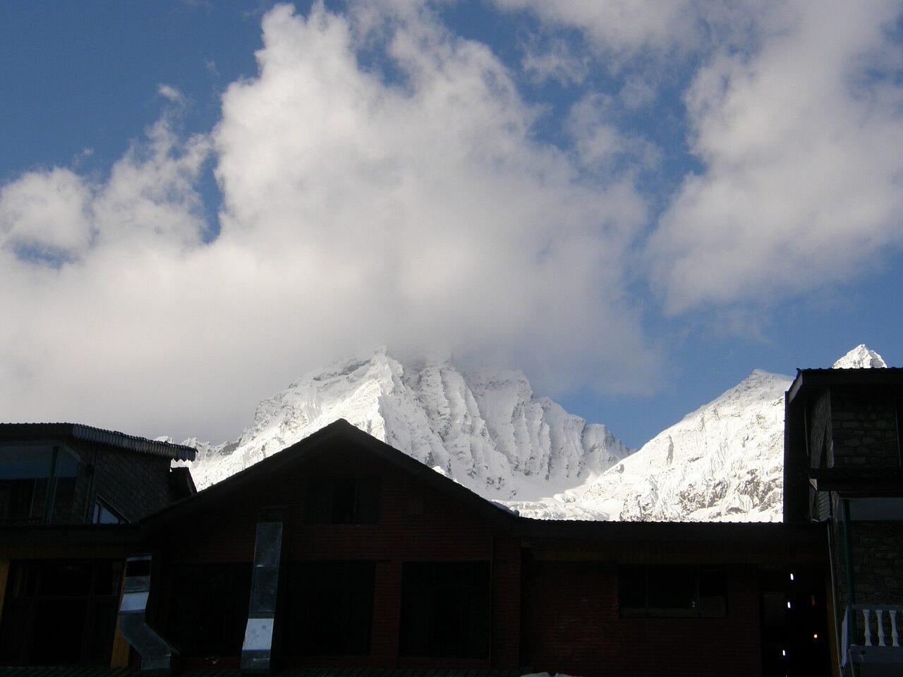 Sonamarg valley with a braided river, pine forest and snow streaks on the high peaks