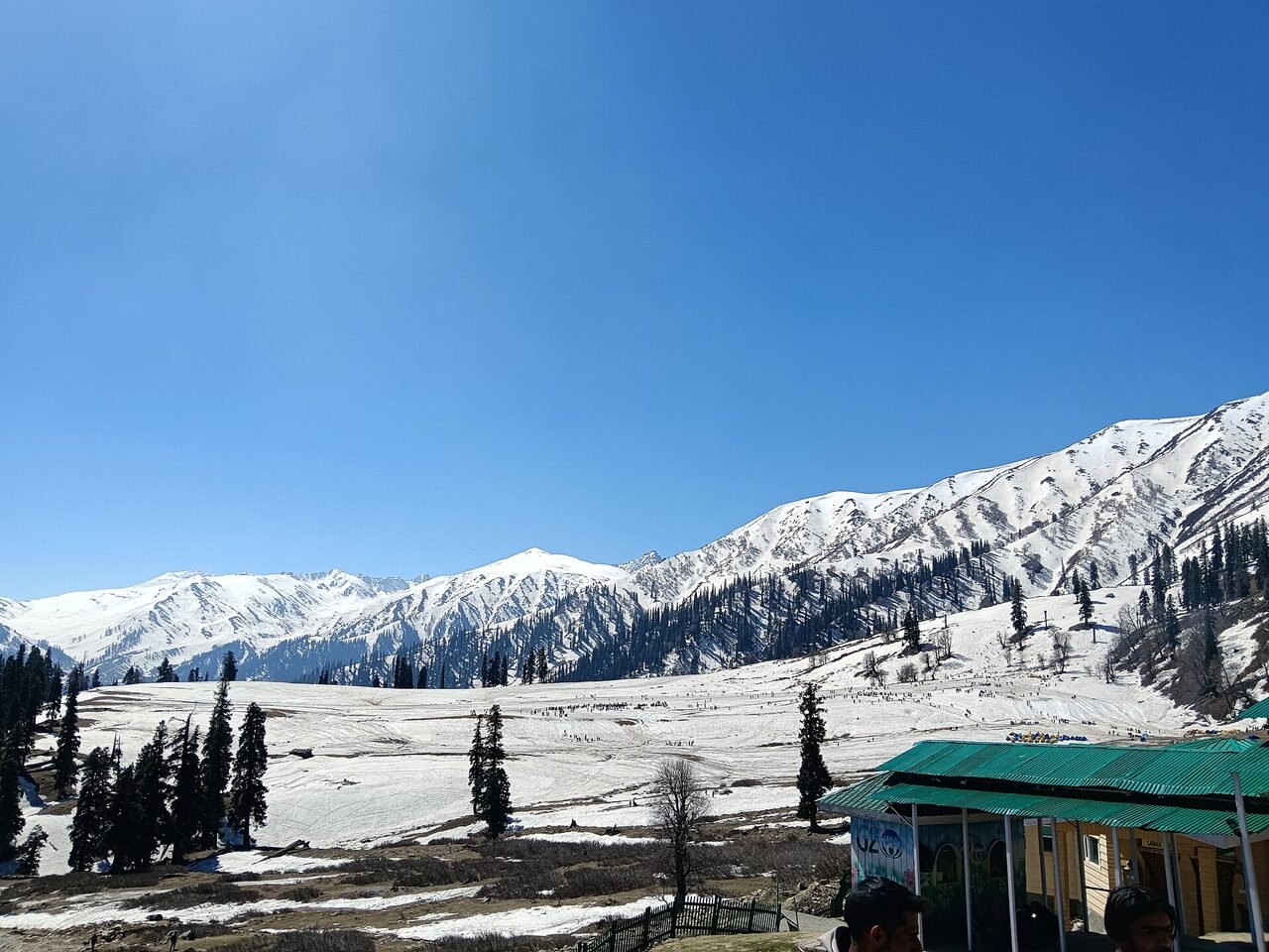 Snow-covered ridges above Gulmarg under a pale winter sky